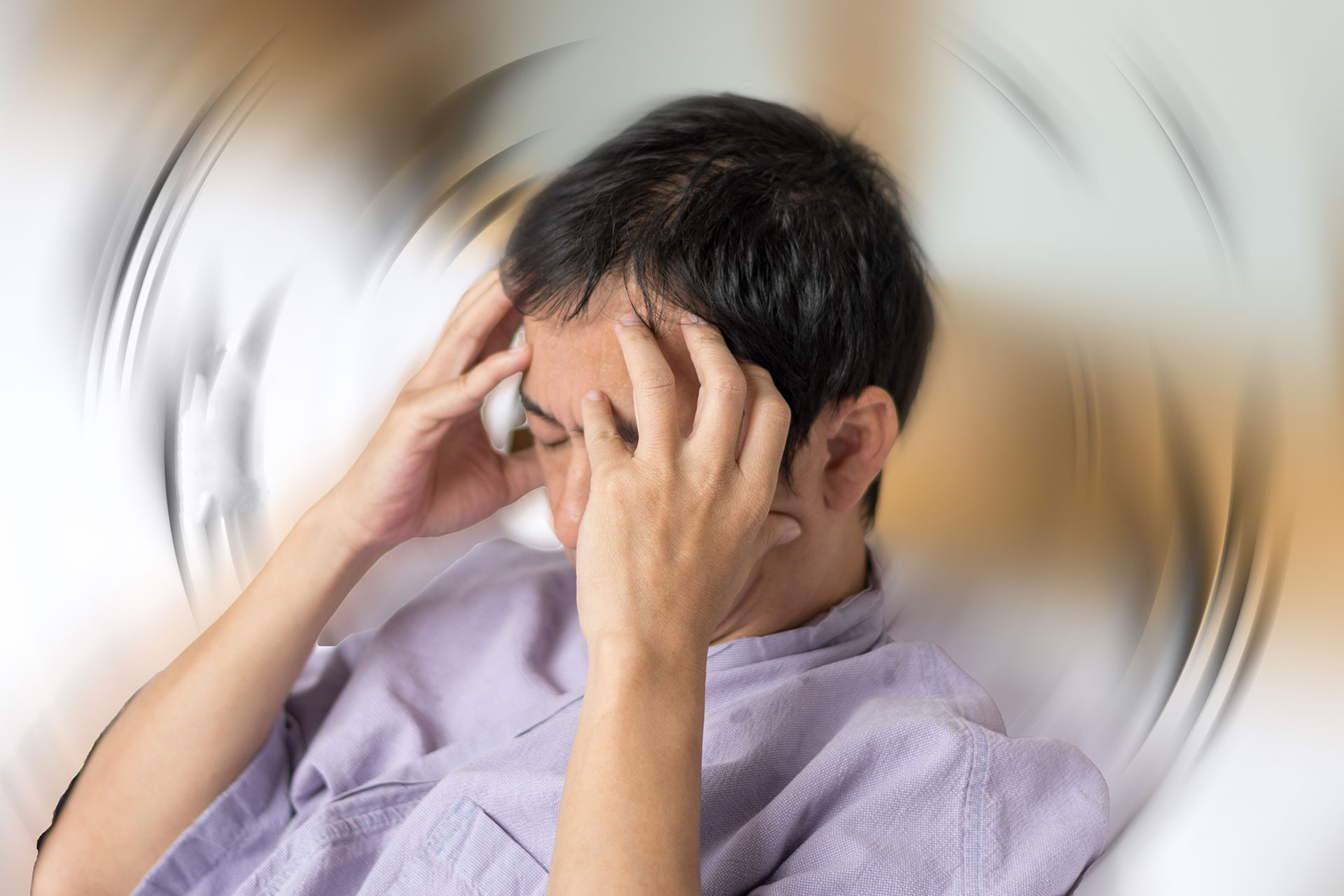 The image shows a person sitting with their head tilted back, appearing to be experiencing discomfort or pain, possibly due to stress or exhaustion.